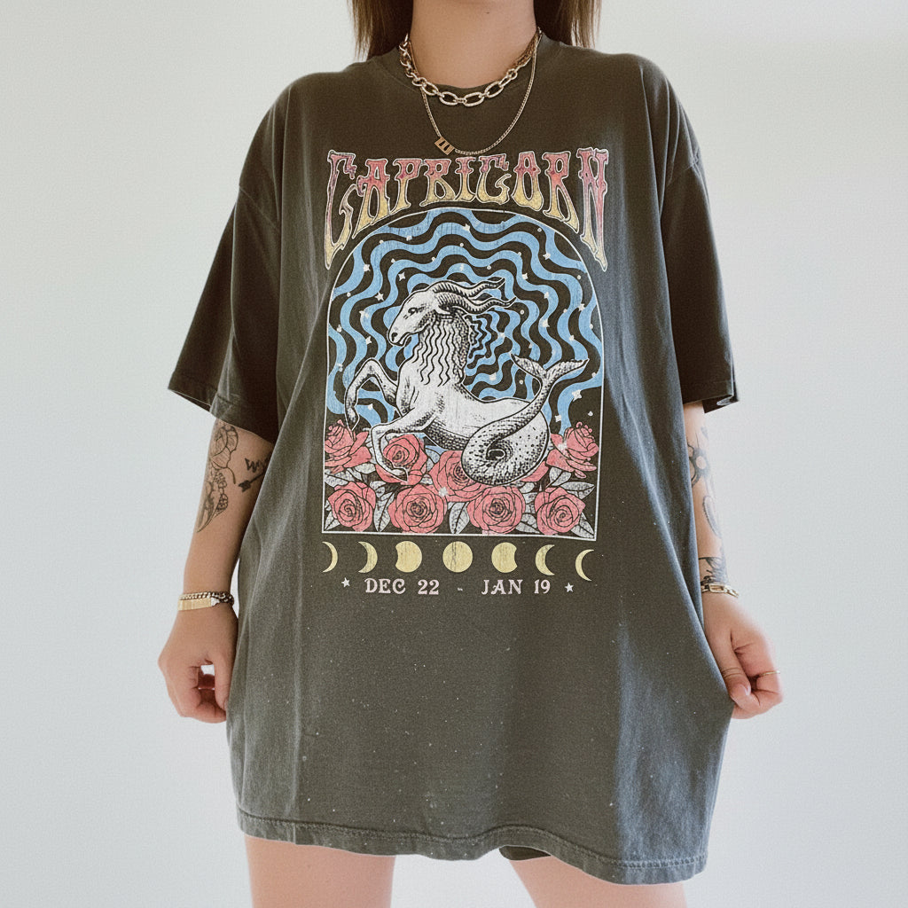Person wearing a t-shirt with Capricorn zodiac design on a plain background
