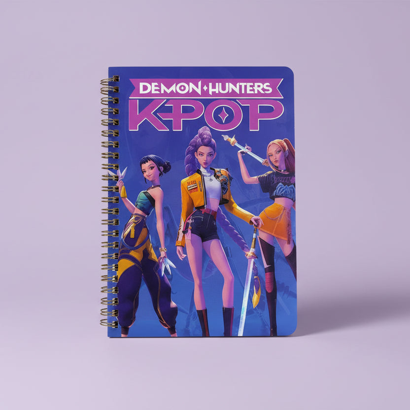 Notebook cover with 'Demon Hunters K-Pop' design featuring three animated characters on a blue background.