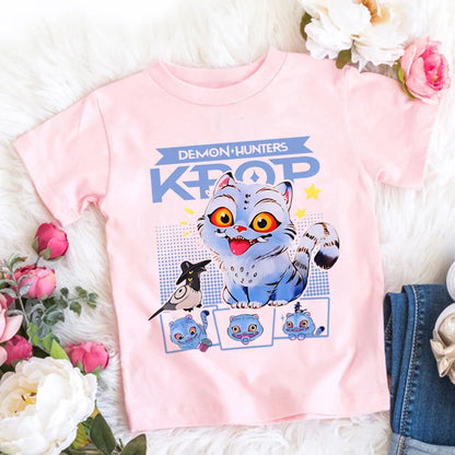 Pink t-shirt with cartoon character and text on a white surface with flowers