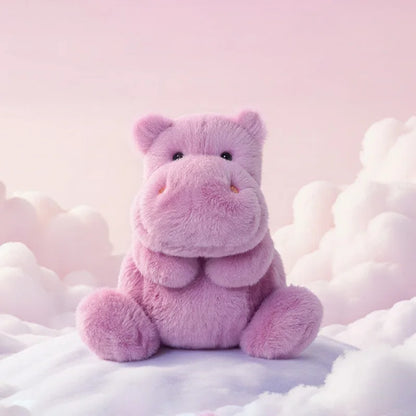 Pink hippo sitting on fluffy white clouds with a soft pink background