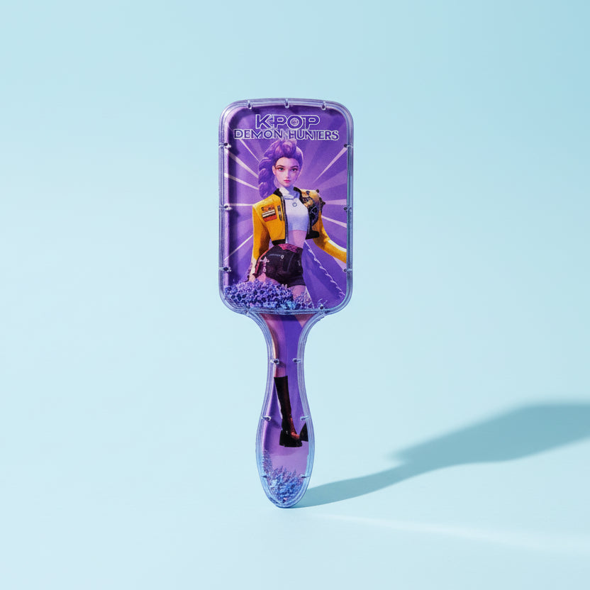 Purple hairbrush with a character design on a white background