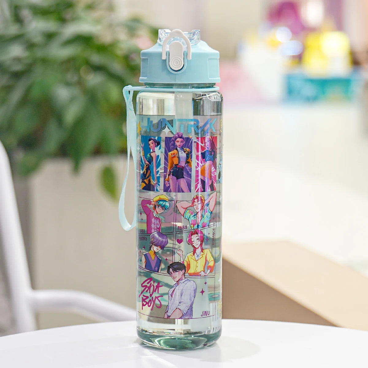 Clear water bottle with colorful design on a white surface