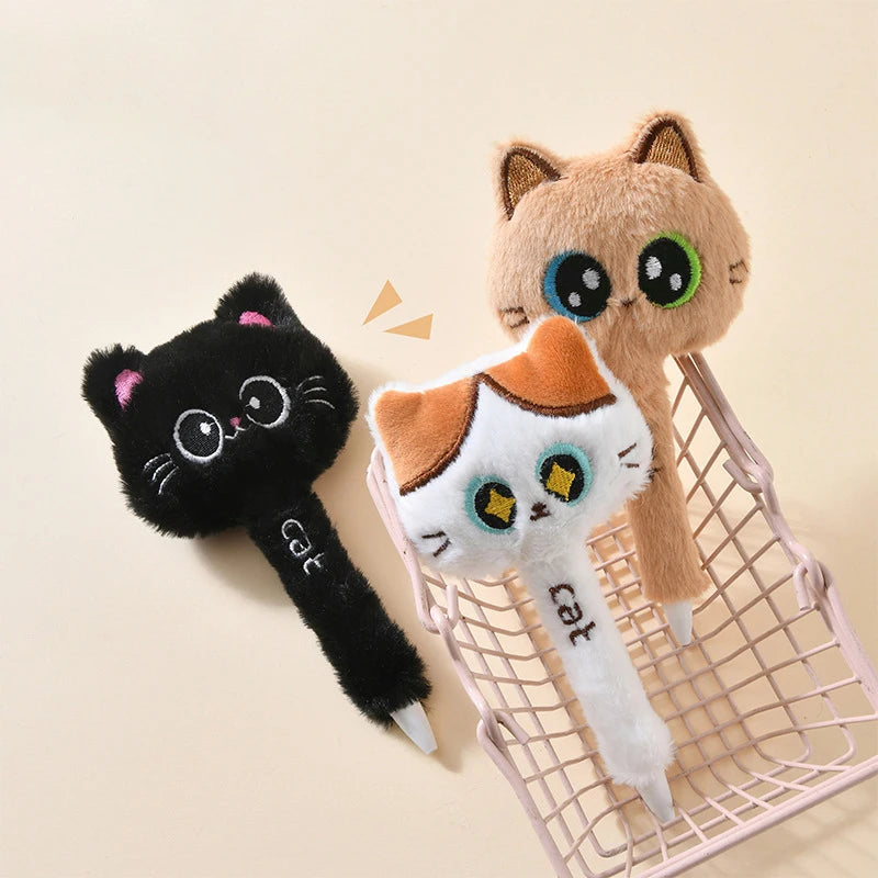Three cat-shaped pens on a beige background