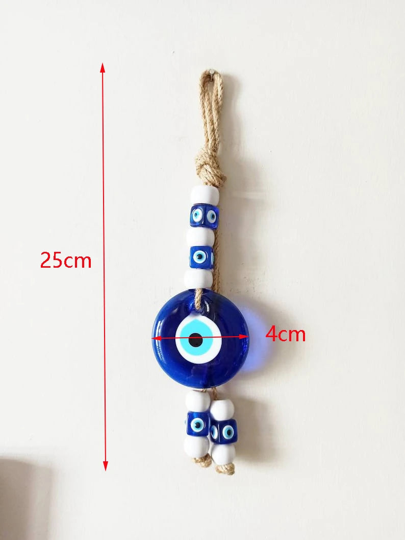 Decorative evil eye charm with measurements on a white background
