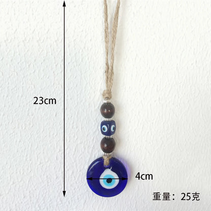 Necklace with a blue evil eye pendant on a white background, showing measurements.