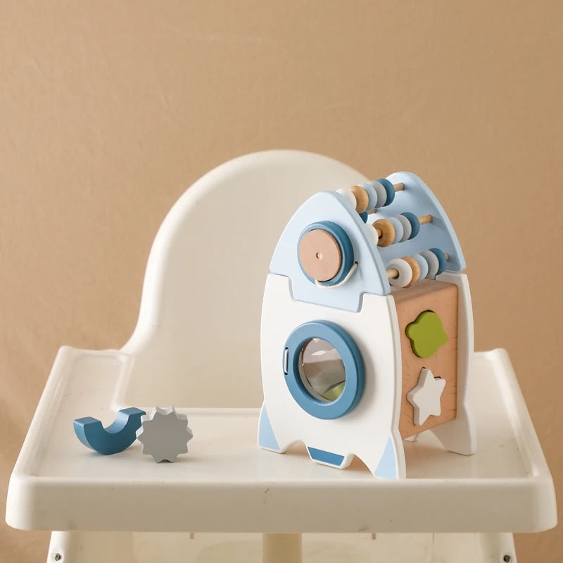 Montessori Wooden Rocket Shape Sorter on high chair