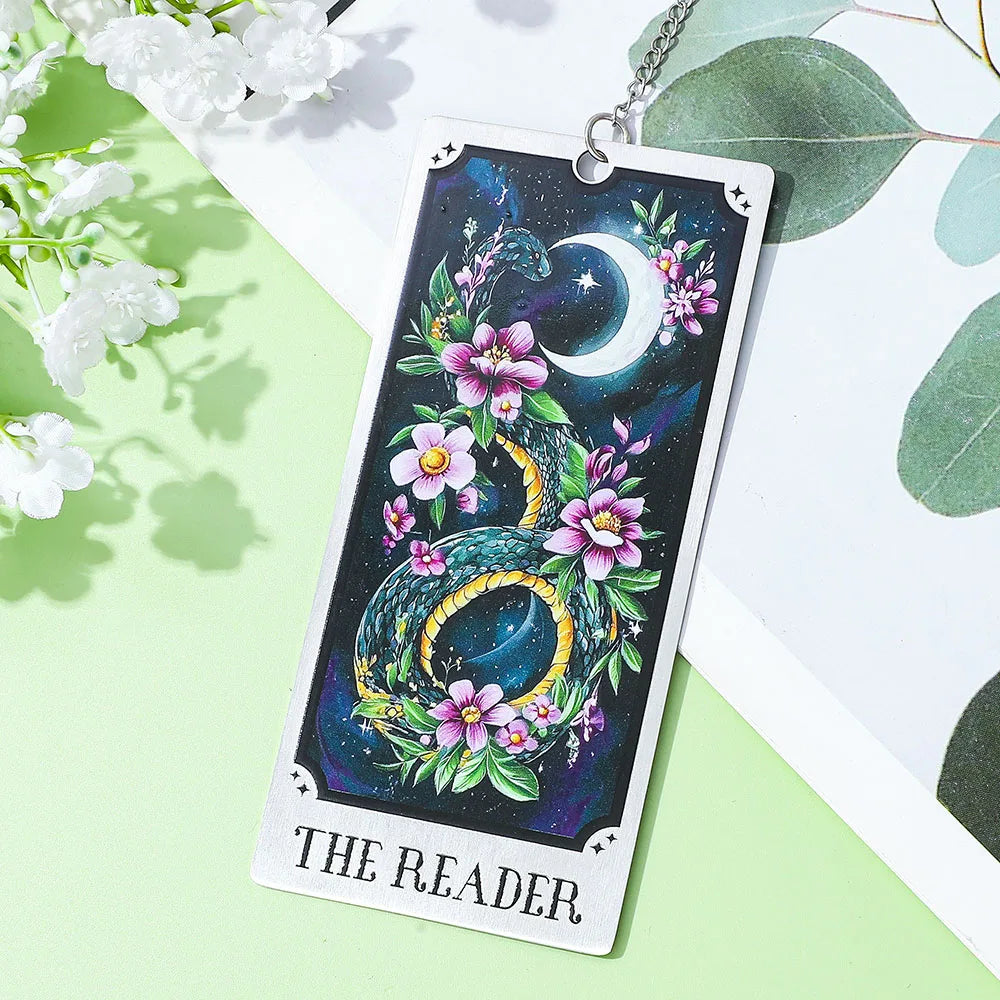 Tarot card with a dragon design, flowers, and a moon symbol on a green and white background.