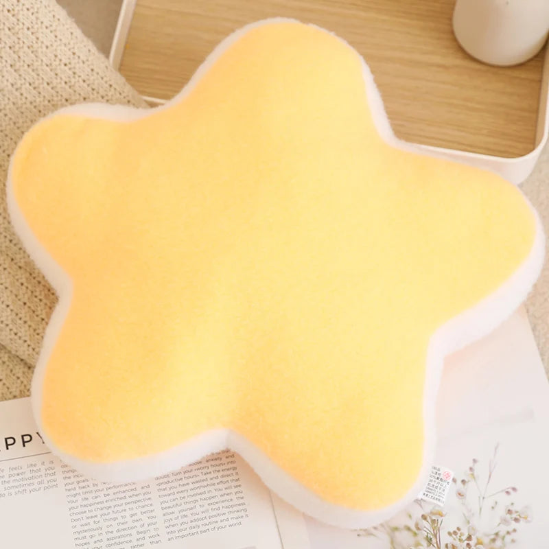 Yellow star-shaped cushion on a surface with a blurred background