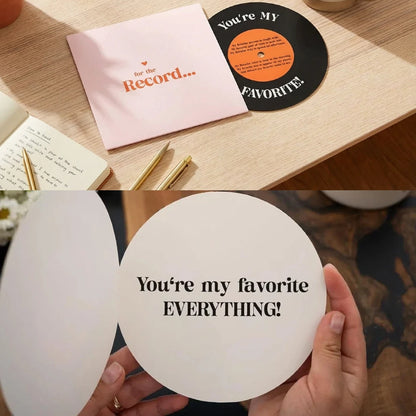 Vinyl record with 'You're My Favorite' text, pink card, and hands holding a round card with similar text on a wooden surface.