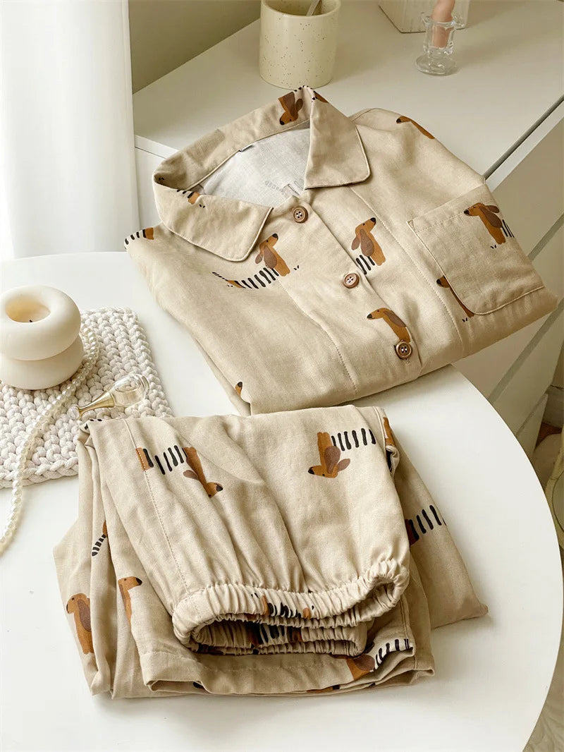 Folded pajama set with dog pattern on a white surface