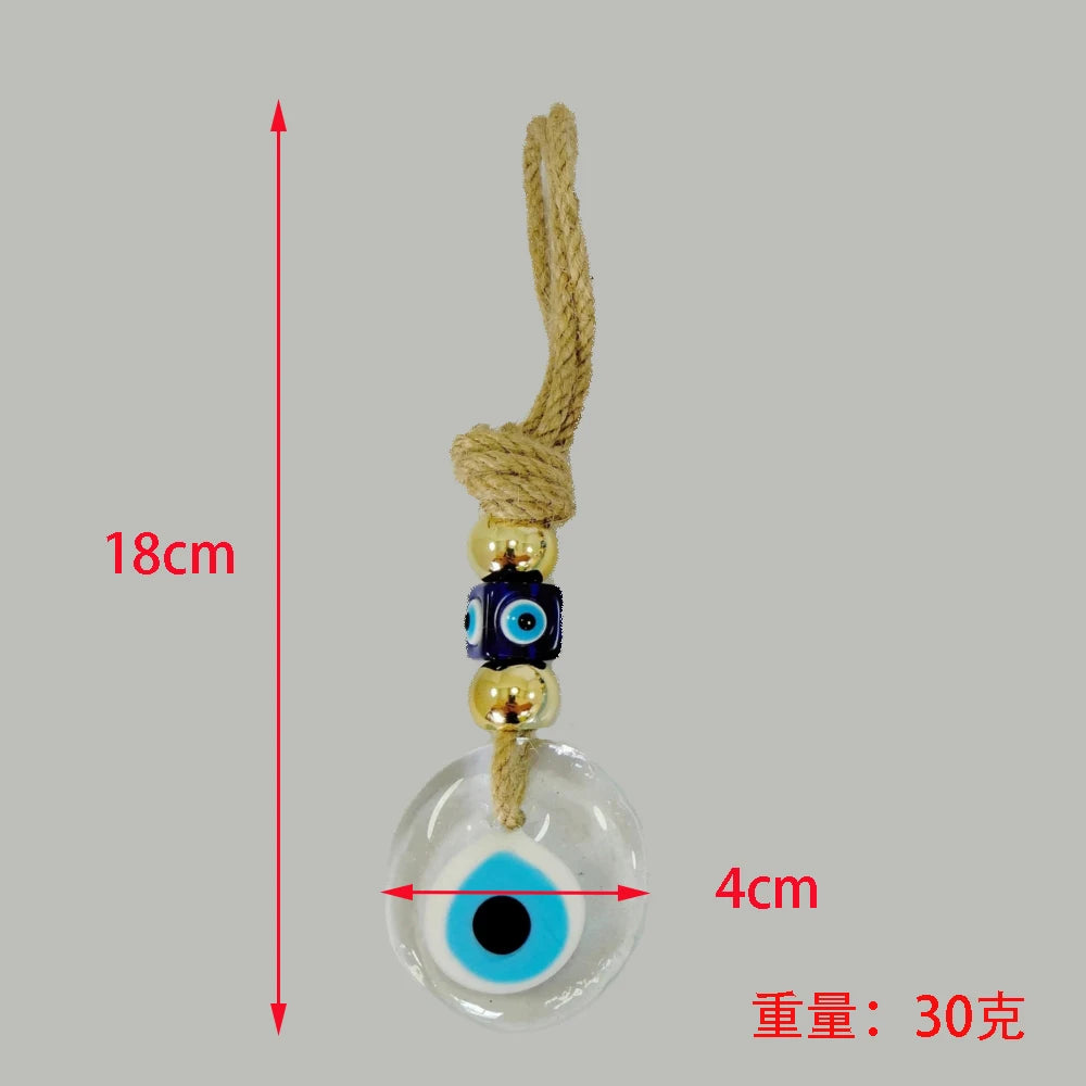 Evil eye charm with measurements on a gray background
