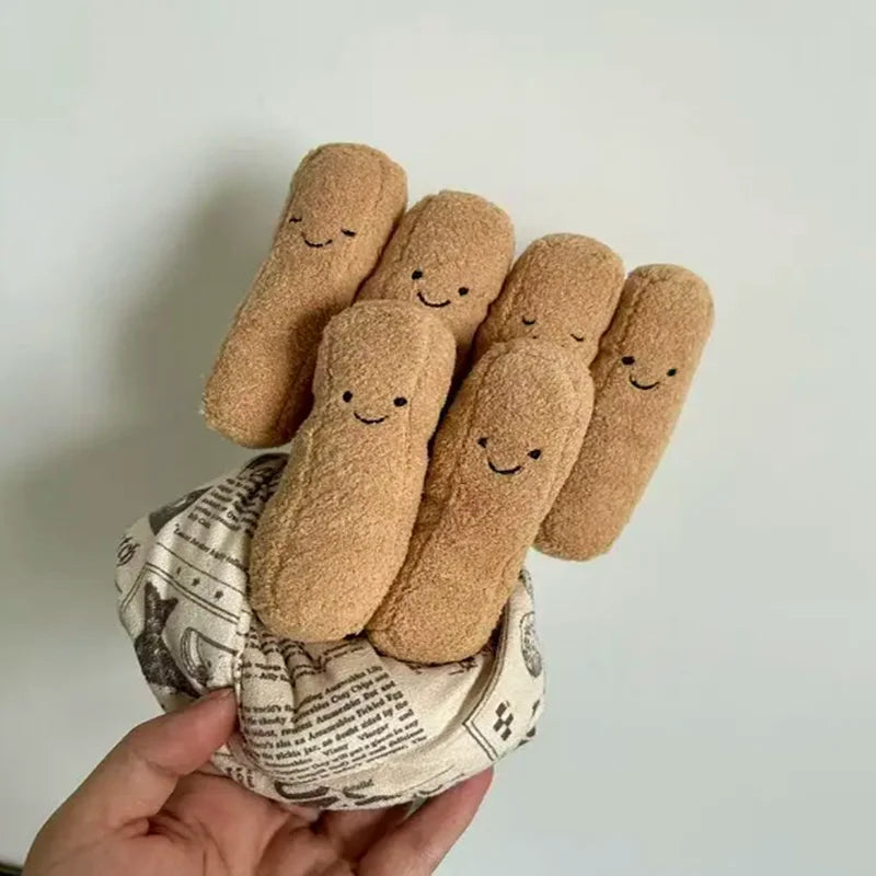 Cork characters with smiling faces held by a hand on a light background