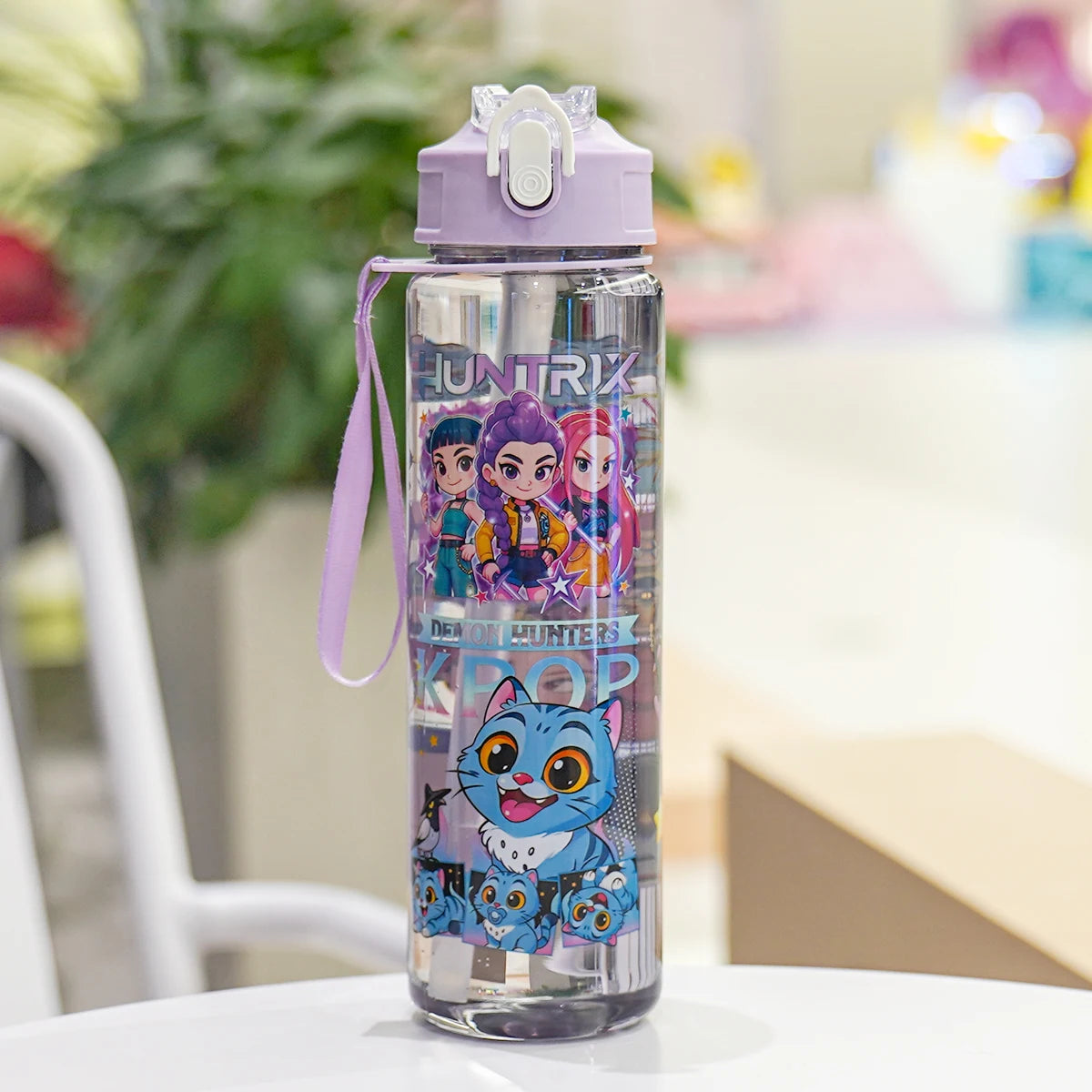 Children's water bottle with cartoon characters on a table