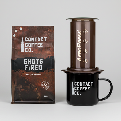Contact Coffee Co. coffee package, AeroPress coffee maker, and black mug on a white background