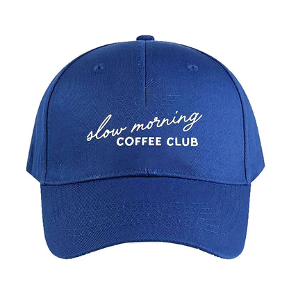 Blue cap with 'slow morning COFFEE CLUB' text on a white background