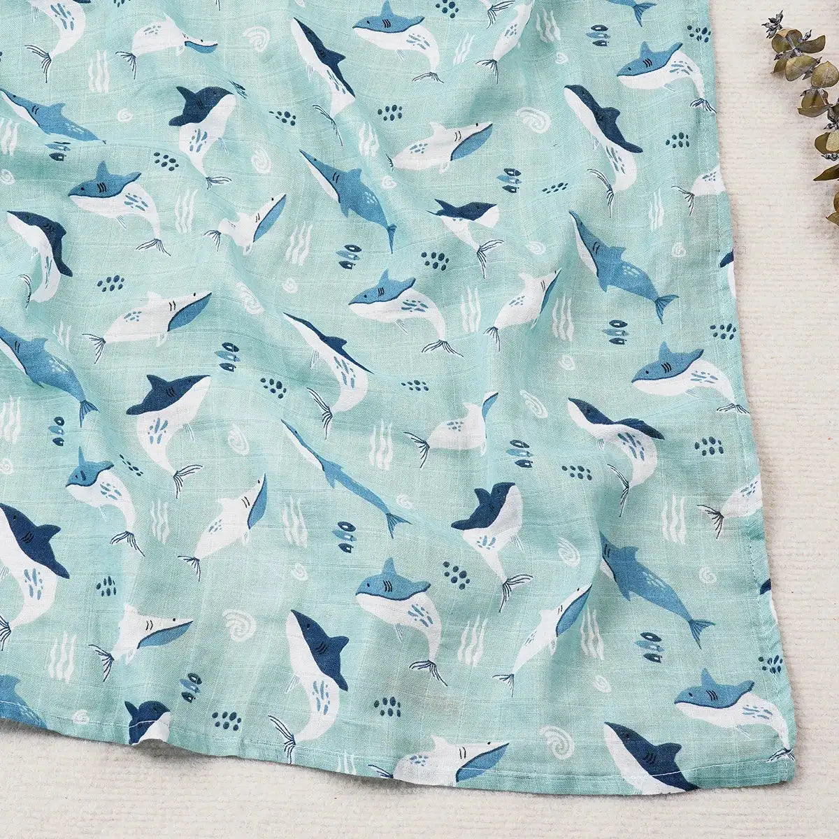 baby blanket with shark pattern on a light blue background