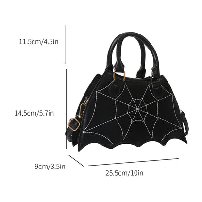 Black handbag with spider web design and measurements on a white background