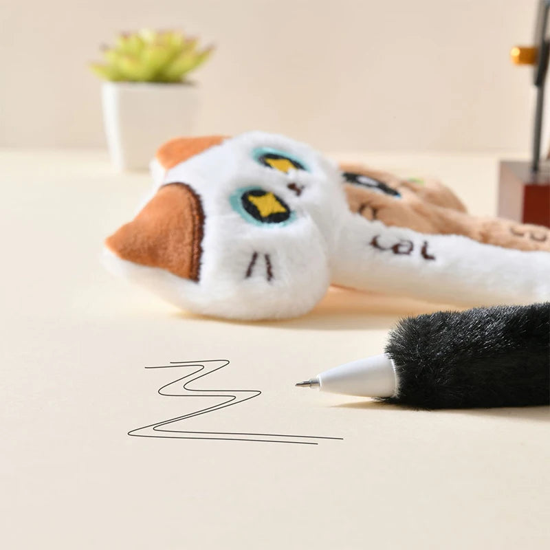Plush toy resembling a cat with a pen on a surface