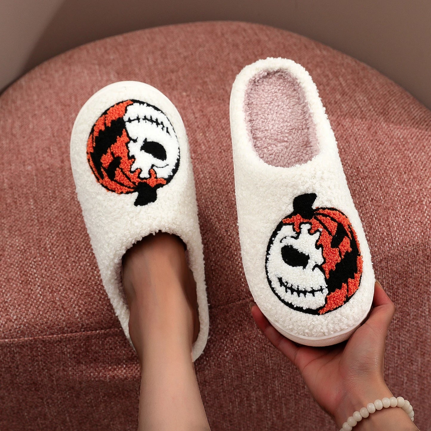 model holding Halloween Pumpkin Embroidered Slippers