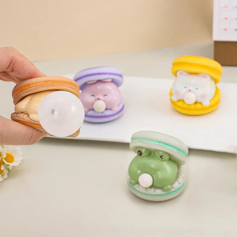 Set of colorful animal-shaped erasers on a white surface with a hand holding one.