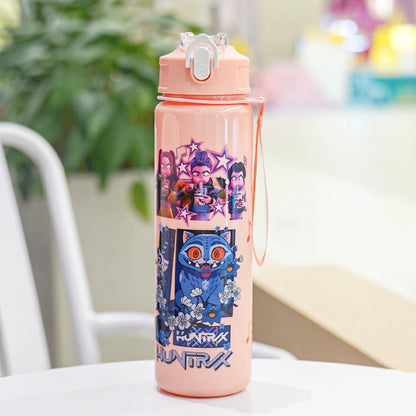 Pink water bottle with cartoon character design on a table