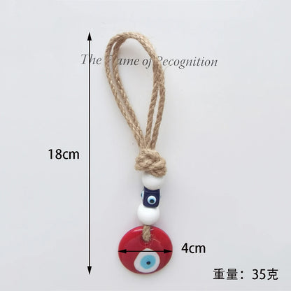 Measurement chart of a decorative keychain with beads and rope on a light gray background