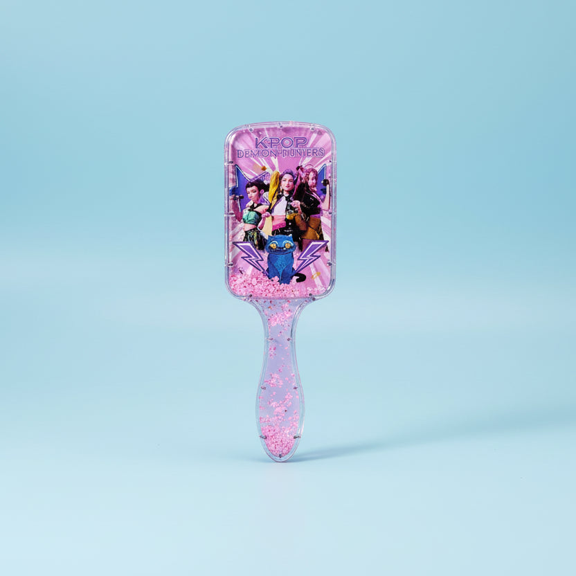 Pink hairbrush with KPOP design on a white background