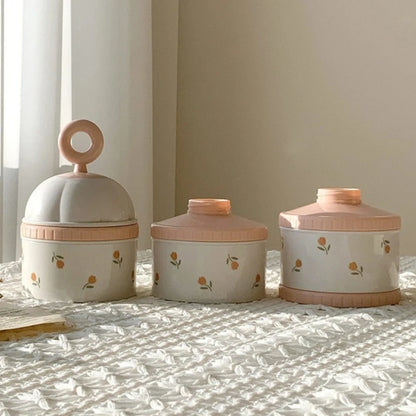 Three Baby Formula Dispenser Storage Containers with floral designs on a textured surface