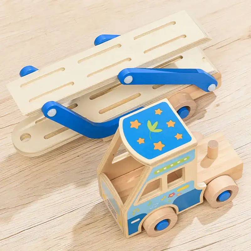 Wooden toy truck with blue roof and star patterns on a wooden surface