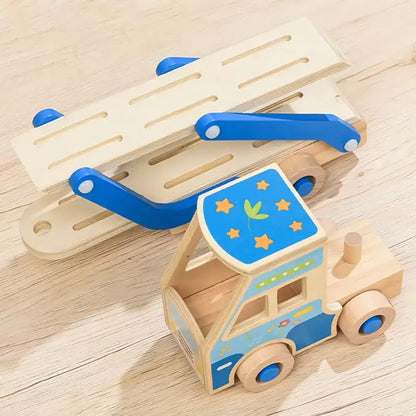 Wooden toy truck with blue roof and star patterns on a wooden surface