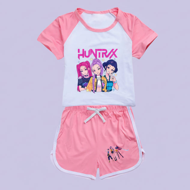 Children's outfit with pink and white top and shorts featuring cartoon characters and 'Huntrx' branding.