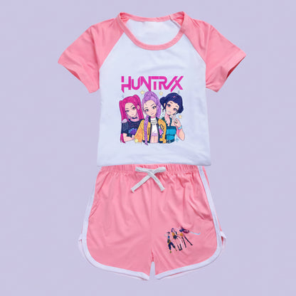 Children's outfit with pink and white top and shorts featuring cartoon characters and 'Huntrx' branding.