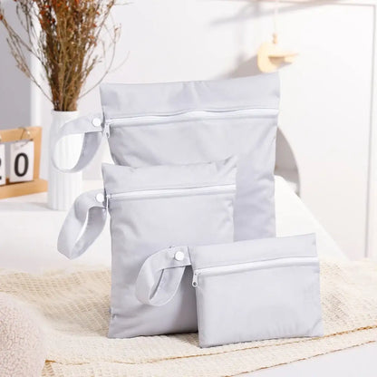 Set of gray pouches on a light surface with a blurred indoor background