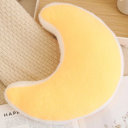 Yellow U-shaped pillow on a wooden surface with a textured fabric background