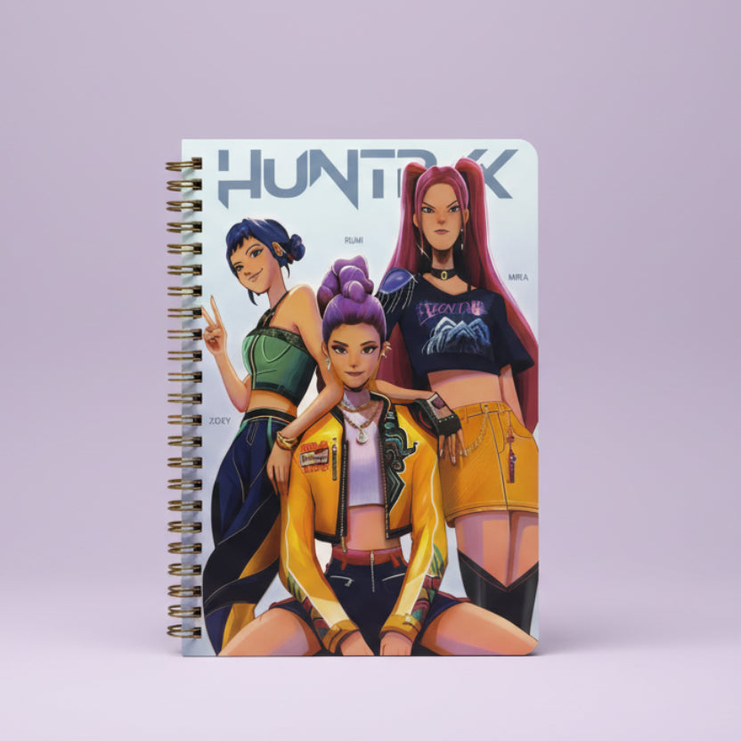 Notebook cover with three animated characters and 'Huntrix' branding.