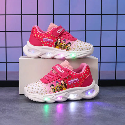 Pink children's sneakers with LED lights on a gray surface and grid background