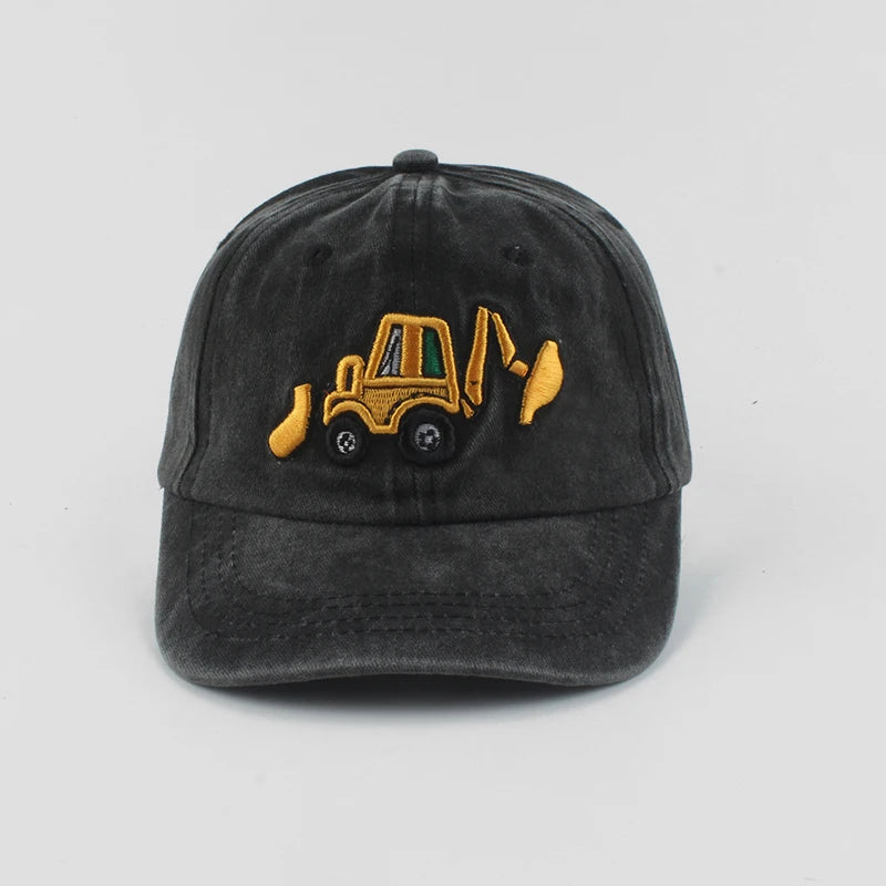 Black cap with yellow bulldozer design on a light gray background