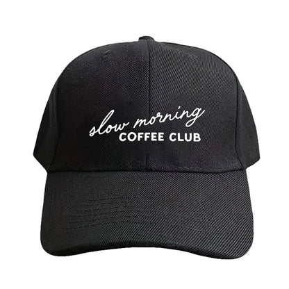 Black cap with 'slow morning COFFEE CLUB' text on a white background