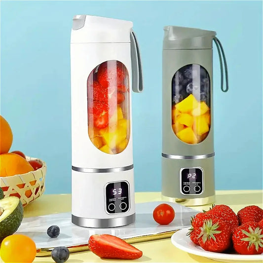 Two portable blenders with fruits inside on a table with a blue background