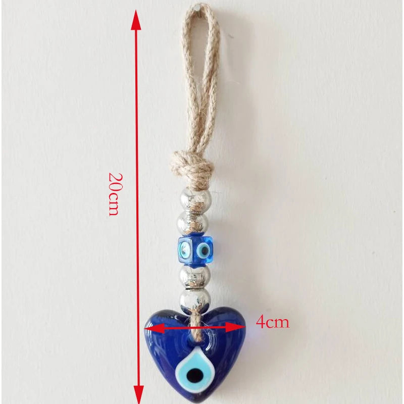 Heart-shaped blue evil eye charm with measurement details on a white background