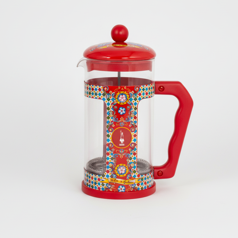 Red French press coffee maker with colorful design on a white background