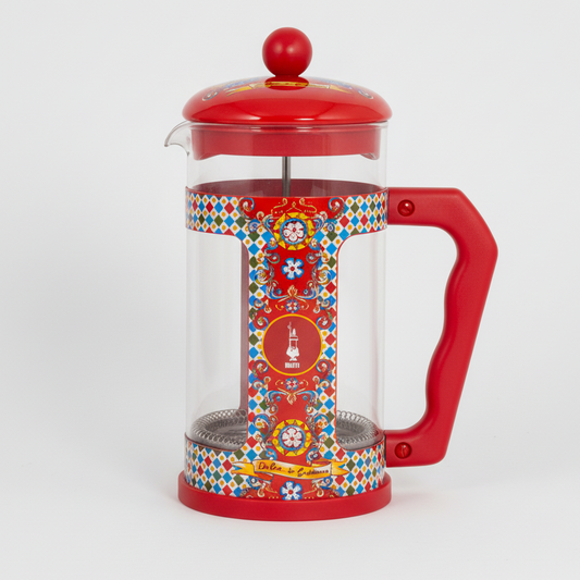 Red French press coffee maker with colorful design on a white background