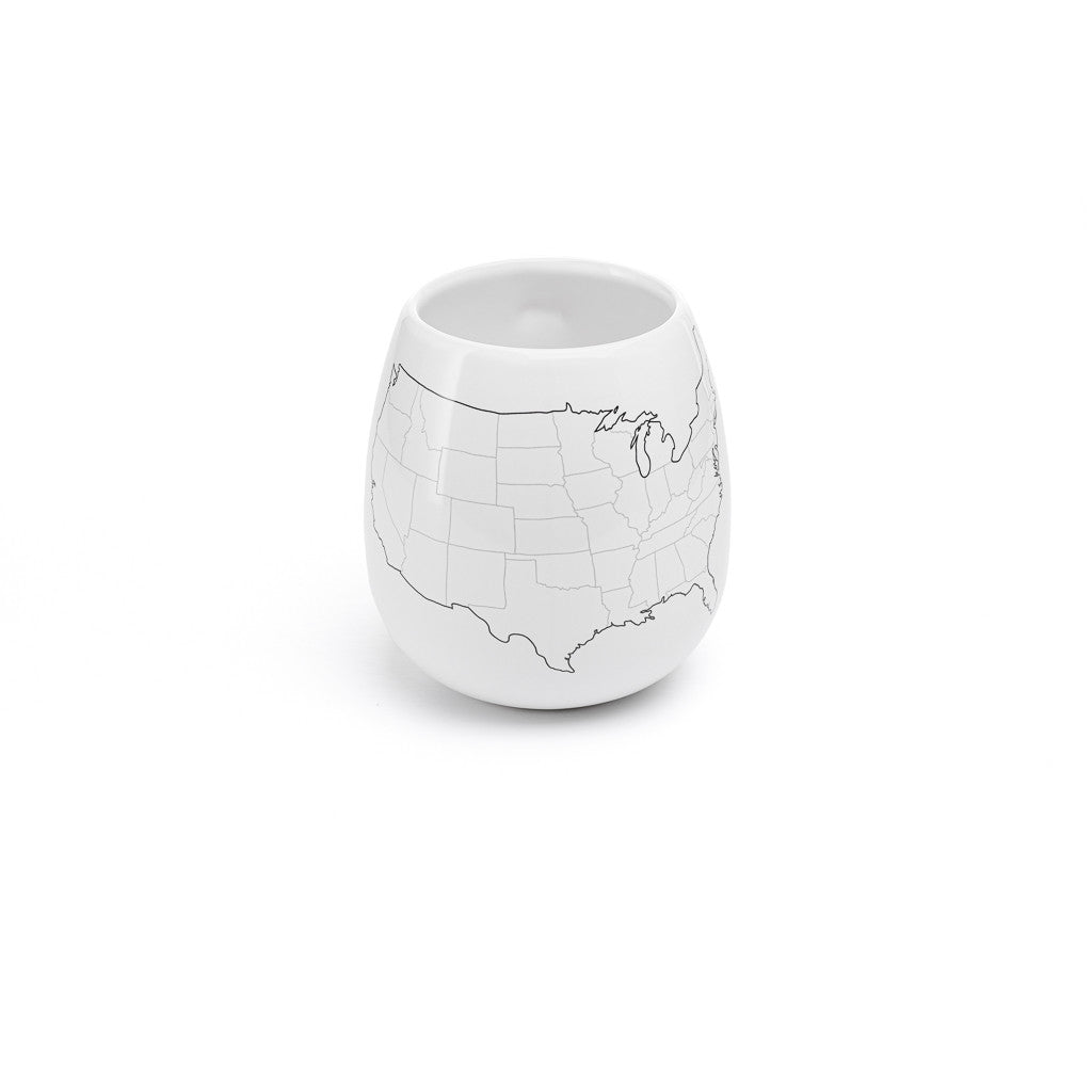 White ceramic cup with a map design on a white background
