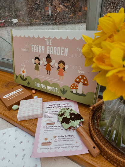 Fairy garden set with instructions and decorative elements on a wooden surface.