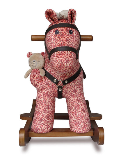 Pink patterned rocking horse with a teddy bear on a white background