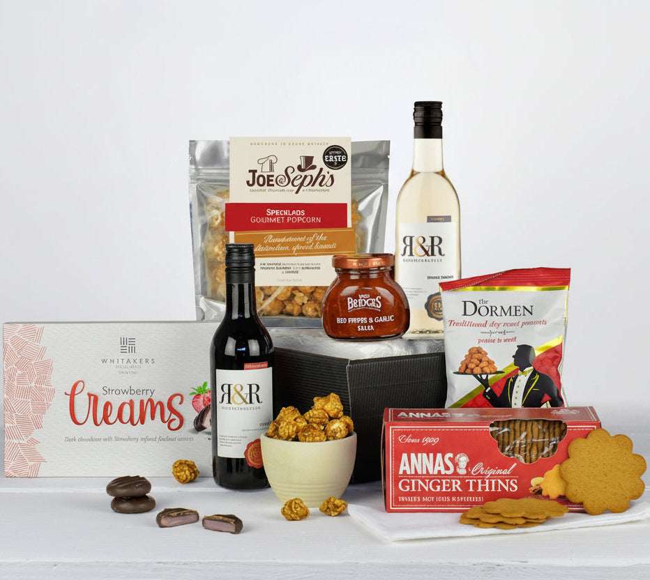 Assorted snacks and drinks on a white surface with a white background