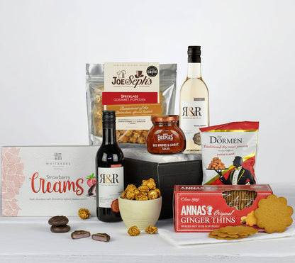 Assorted snacks and drinks on a white surface with a white background