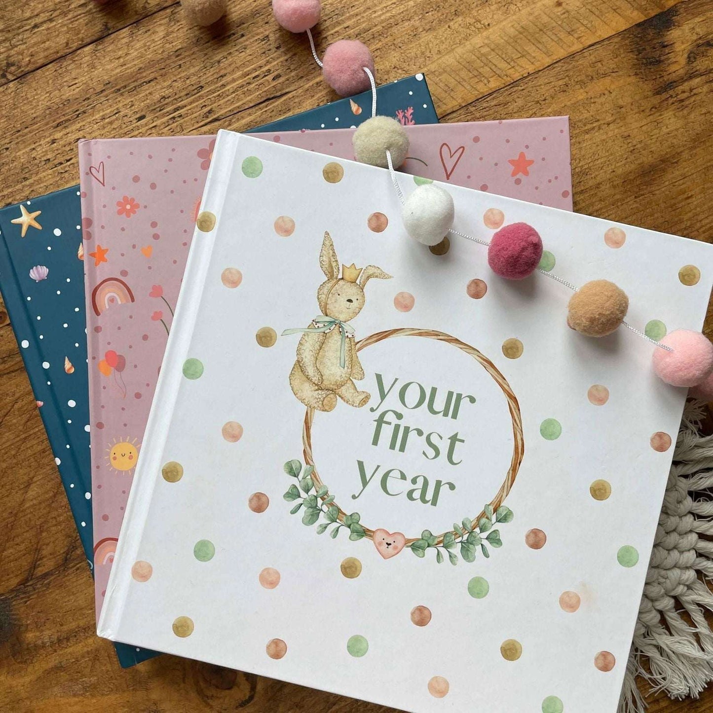 Book titled 'your first year' with a bunny illustration on a wooden surface.