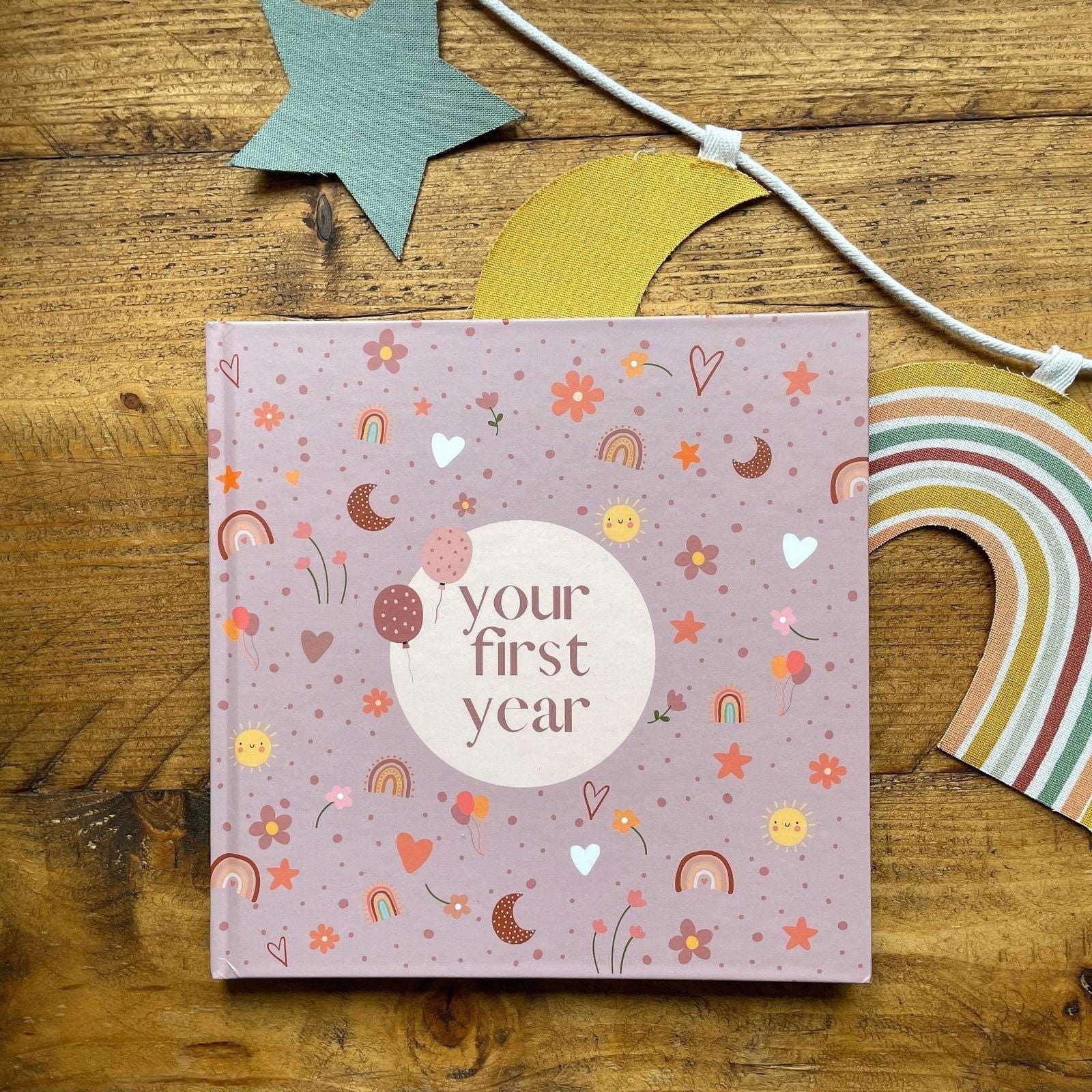 Book titled 'your first year' with decorative elements on a wooden surface