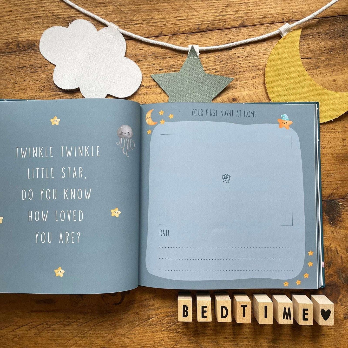 Open book with star-themed text and illustrations on a wooden surface with decorative elements.